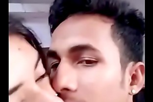Girlfriend boyfriend kissing in a room