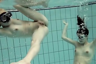 Girls swimming underwater and enjoying eachother